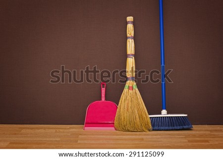 Cleaning up the apartment: brooms and a dustpan