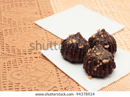 Chocolate truffle cakes with peanuts on napkins