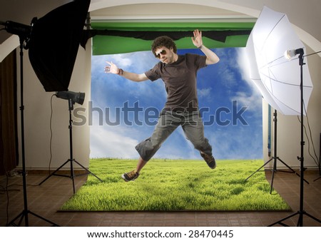 Edited studio shoot of a young man jumping over blue sky outdoors