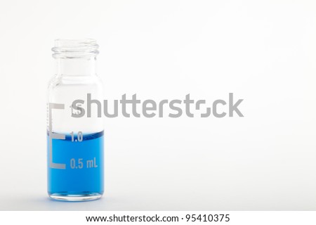 Sample vial for chromatography filled with one milliliter of blue liquid. Isolated on white. Please see my portfolio to find more similar images