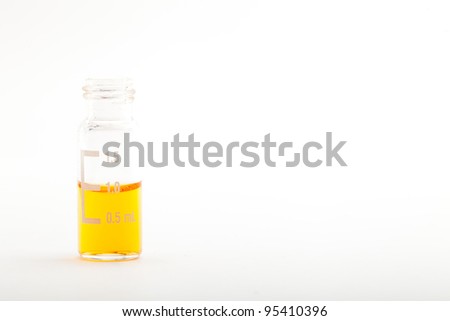 Sample vial for chromatography filled with one milliliter of orange liquid. Isolated on white. Please see my portfolio to find more similar images