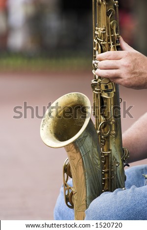 Sax player in Boulder, Colorado holding his sax on his knees.