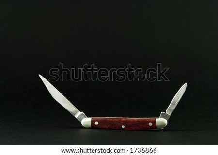 Small pocket knife with both blades open.  Isolated on matte black background.