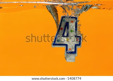 Happy 4th Birthday, Happy Anniversary, or July 4th/Independence Day. High-speed photo of candle frozen in time as it is splashing into clear water.