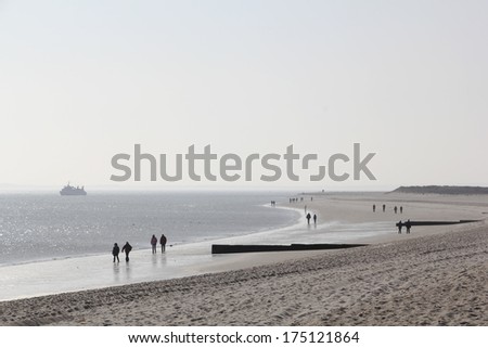 Hiker at the beach of Sylt in the morning light