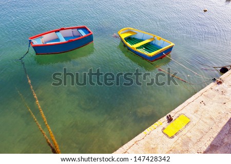 two small coloured boats waiting for who knows what