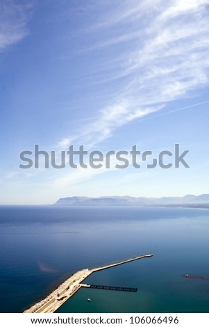 Top view of port and ship\'s mall going deep into the sea under the beautiful blue sky