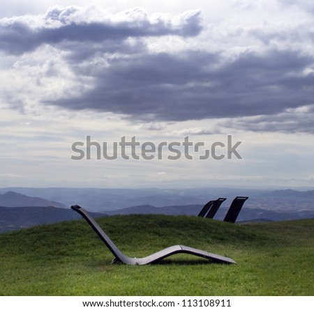 Relaxing chairs in an open air overlooking mountains