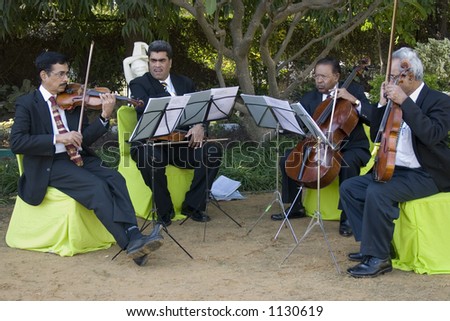 Four musicians playing the violin
