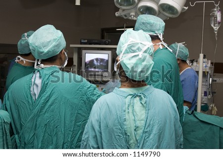 Surgeons monitoring a patientâ€™s condition
