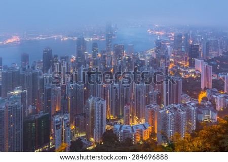 Hongkong, China- June 1, 2015: Hong Kong the scenes, victoria harbour from the peak bird view, in the mist with bad weather, coast to coast after rain, nimbus landscape on the trails.