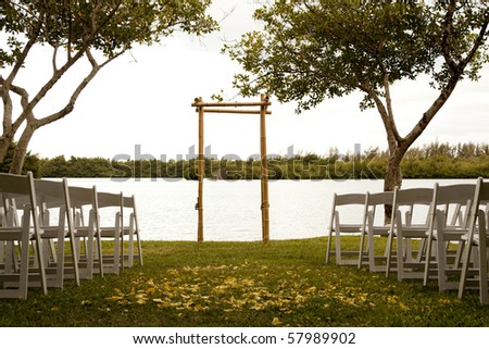 stock photo Tranquil wedding setting with trellis water and trees