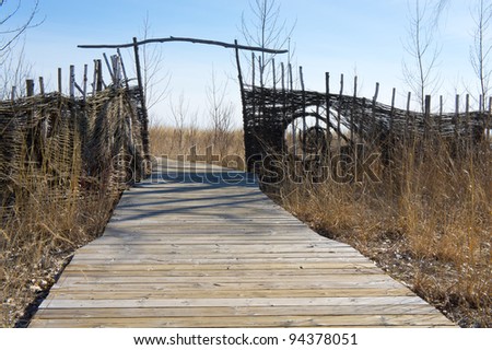 Boardwalk path with a fence and a gate.