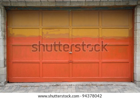 Old garage door painted in yellow and orange