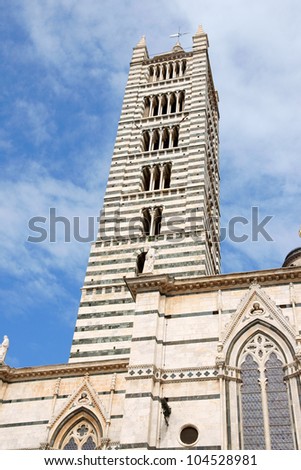 Bell tower of Siena Cathedral (Duomo di Siena) in Tuscan gothic style, Tuscany, Italy. This Cathedral is dedicated to Most Holy Mary of Assumption.