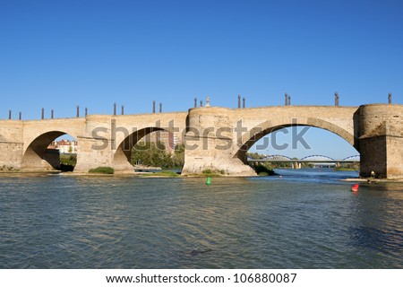 Stone Bridge (Puente de Piedra) over river Ebro in Zaragoza, Spain. It is also called Lion Bridge because 2 couples of bronze lions on pillars are placed at each side of the bridge.