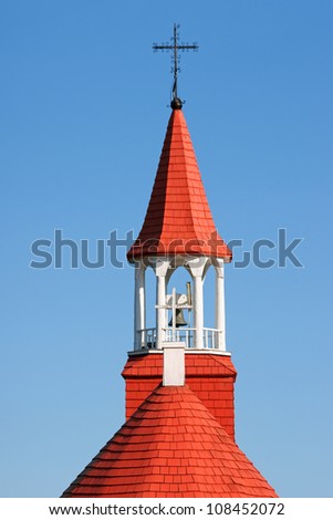 The wooden red roof of the old church of Tadoussac, also known as \
