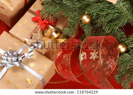 Christmas presents under the Christmas tree over a red background