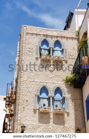 PENISCOLA, SPAIN - MAY 31: The House of Shells (La Casa de las Conchas) on May 31, 2010 in Peniscola, Spain. This unusual house has a facade made of sea shells and windows in Arabic style.