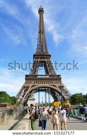 PARIS, FRANCE - AUGUST 17: the Eiffel Tower (Tour Eiffel) on August 17, 2013 in Paris, France. It was built between 1887 and 1889 for the World\'s Fair (Expo 1889). A lot of people around.