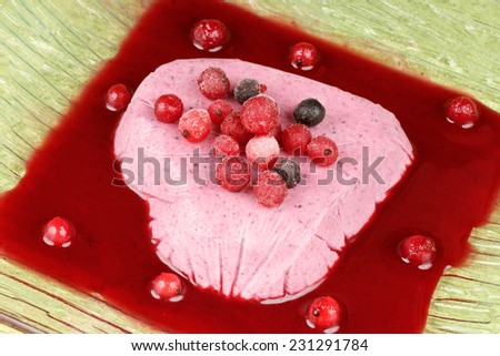 Heart shaped wild berries bavarian cream (bavarese) served with wild berries and wild berries sauce for a Valentine\'s Day dinner.