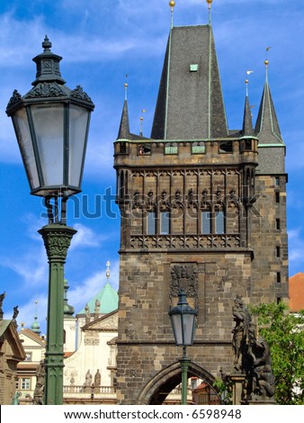 Old Town bridge tower at one end of Charles bridge on Vltava river in Prague. View from the middle of the bridge.