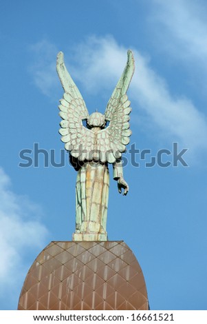 Back of an angel copper statue from the roof of Notre Dame de Bonsecours Chapel overlooking the old port of Montreal