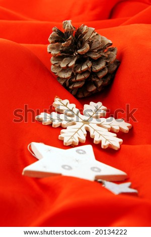 Wooden Christmas decorations over a red tissue background