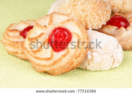 Closeup of assorted sicilian almond pastries decorated with candies cherries, icing sugar and granulated sugar. Selective focus.