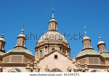 Basilica-Cathedral of Our Lady of the Pillar in Zaragoza is supposed to be the first dedicated to Holy Mary. The first church on this site was Romanesque, the present one is Baroque style