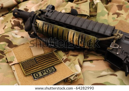 Submachine gun, US flag and blood type patch multicam camo background