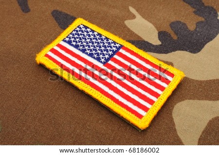 US flag patch on woodland camo background
