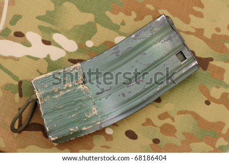 Airsoft magazine for M4 rifle with mag pull on multicam background