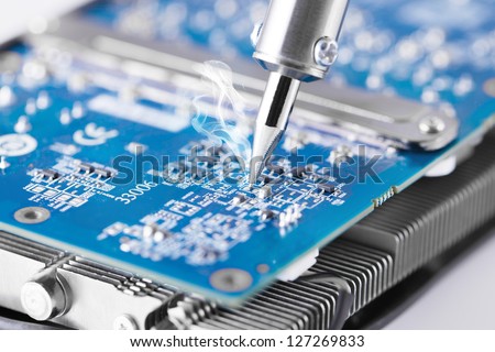 Fixing microcircuit with soldering iron