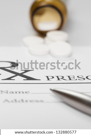 Blank medical prescription with pills on table