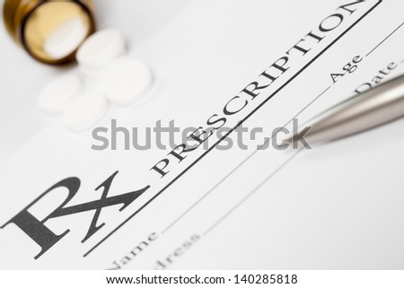 Medical stuff - prescription, pills and pen on table