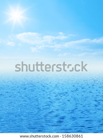 Blue sea with sun and clouds on sky
