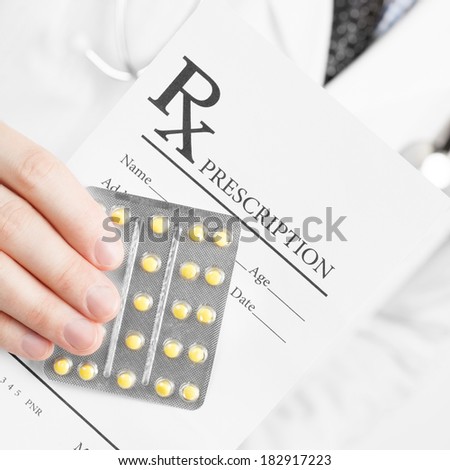 Medical doctor holding prescription in his hand - 1 to 1 ratio image