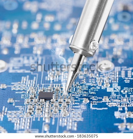 Microcircuit being fixed with soldering iron - sharp photo - 1 to 1 ratio