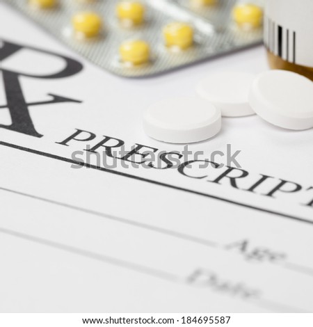Medical prescription and several pills on table - 1 to 1 ratio