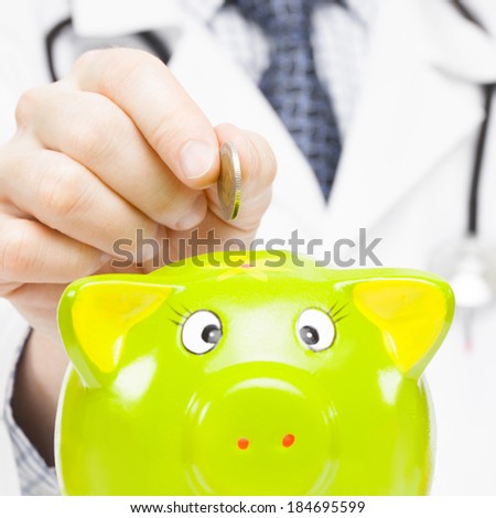 Doctor putting a coin into piggy bank as an idea for healthcare insurance and savings for medical expenses - 1 to 1 ratio