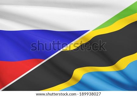 Flags of Russia and United Republic of Tanzania blowing in the wind. Part of a series.