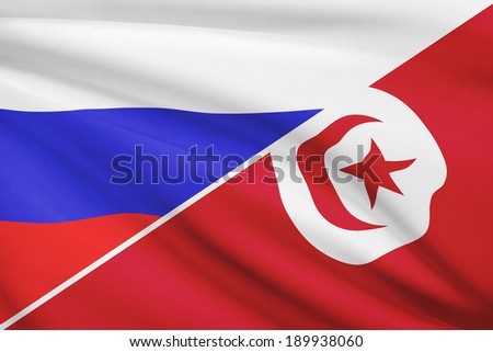 Flags of Russia and Tunisian Republic blowing in the wind. Part of a series.