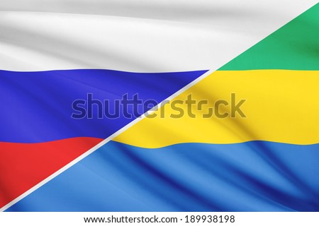 Flags of Russia and Gabonese Republic blowing in the wind. Part of a series.