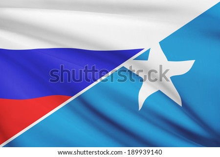 Flags of Russia and Federal Republic of Somalia blowing in the wind. Part of a series.