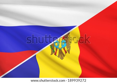 Flags of Russia and Republic of Moldova blowing in the wind. Part of a series.
