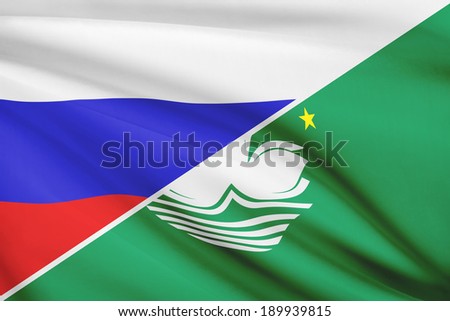 Flags of Russia and Macao Special Administrative Region of the People\'s Republic of China blowing in the wind. Part of a series.