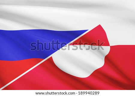 Flags of Russia and Greenland blowing in the wind. Part of a series.