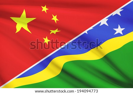Flags of China and Solomon Islands blowing in the wind. Part of a series.