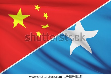 Flags of China and Federal Republic of Somalia blowing in the wind. Part of a series.